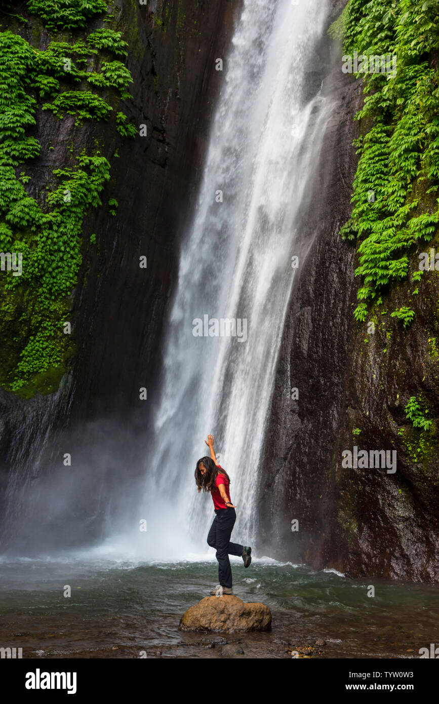 Woman in front of a waterfall in Bali, Indonesia Stock Photo - Alamy