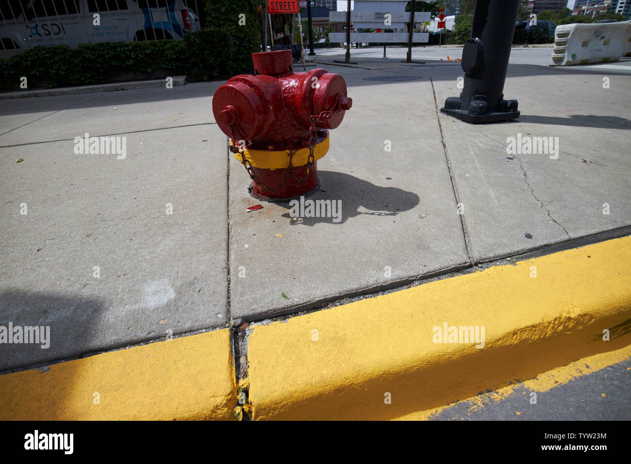 yellow painted kerb indicating no parking next to a fire hydrant in downtown Chicago IL USA Stock Photo