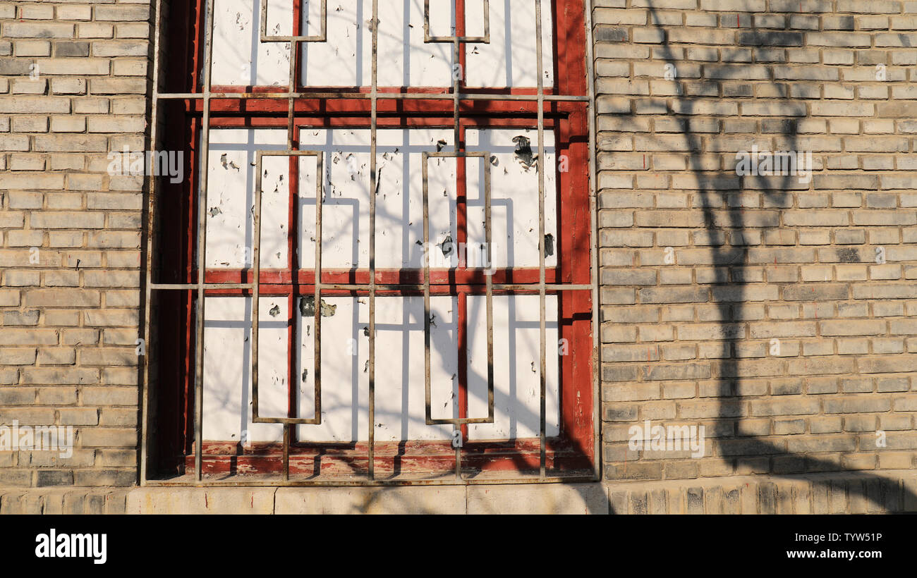 Nostalgic brick walls, mottled tree shadows Stock Photo
