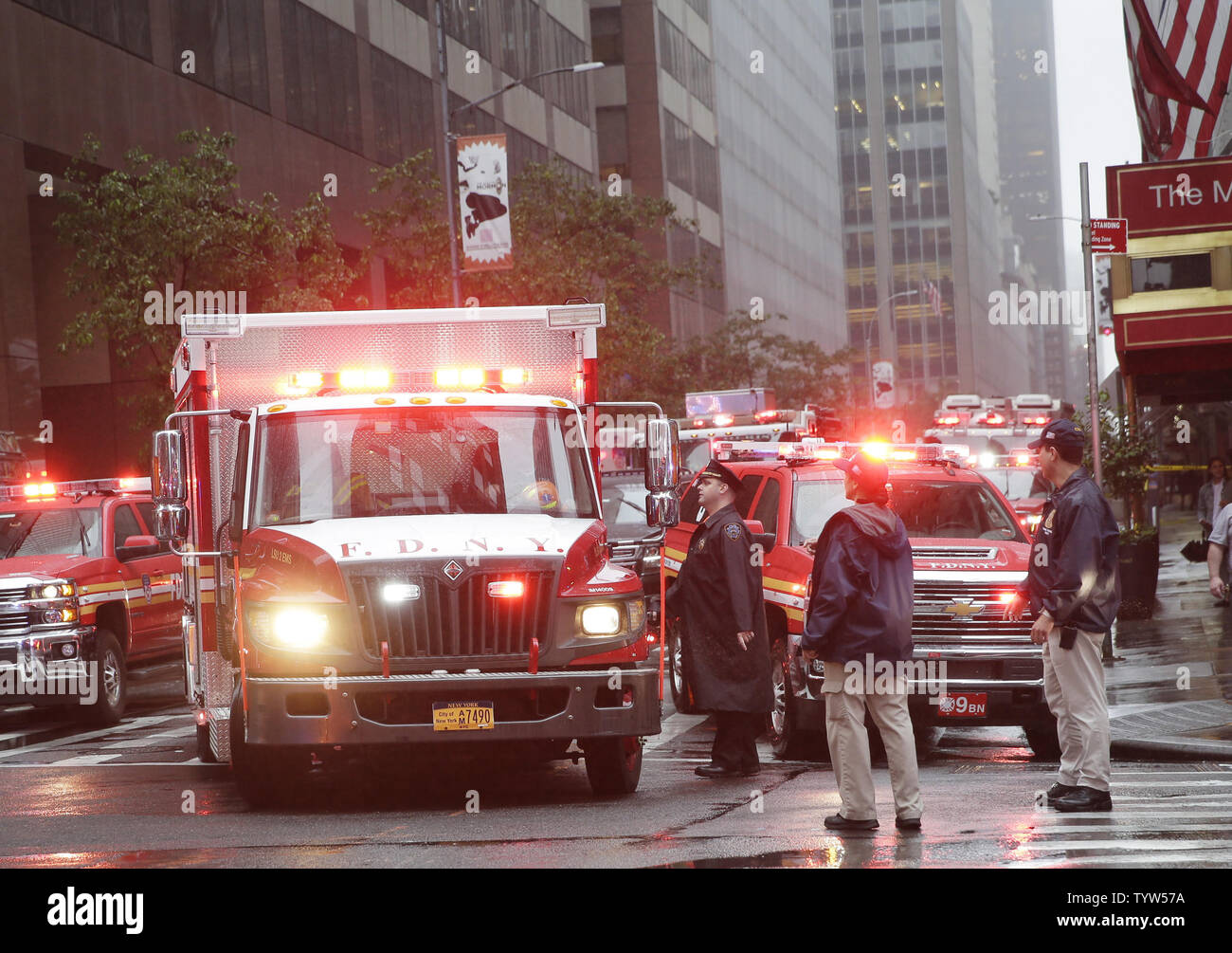 FDNY fire trucks surround the scene after a helicopter crashed on top