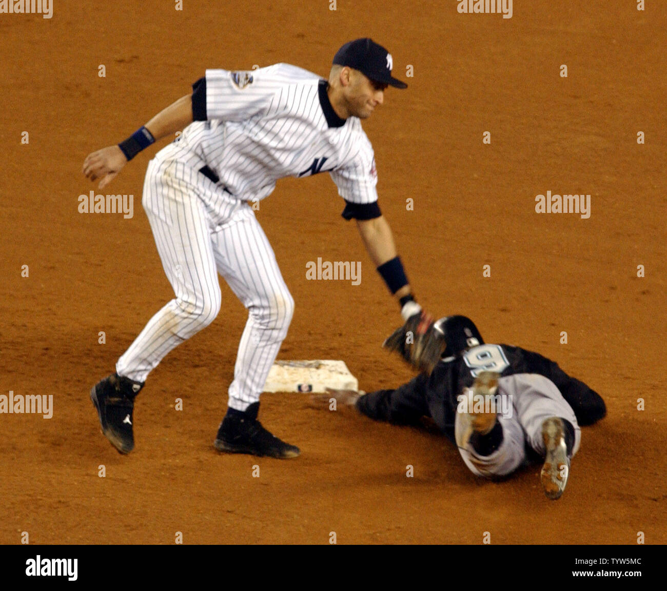The Florida Marlins' Juan Pierre steals second base as the New York  Yankees' Derek Jeter applies the tag in Game 1 of the World Series at  Yankee Stadium on October 18, 2003.
