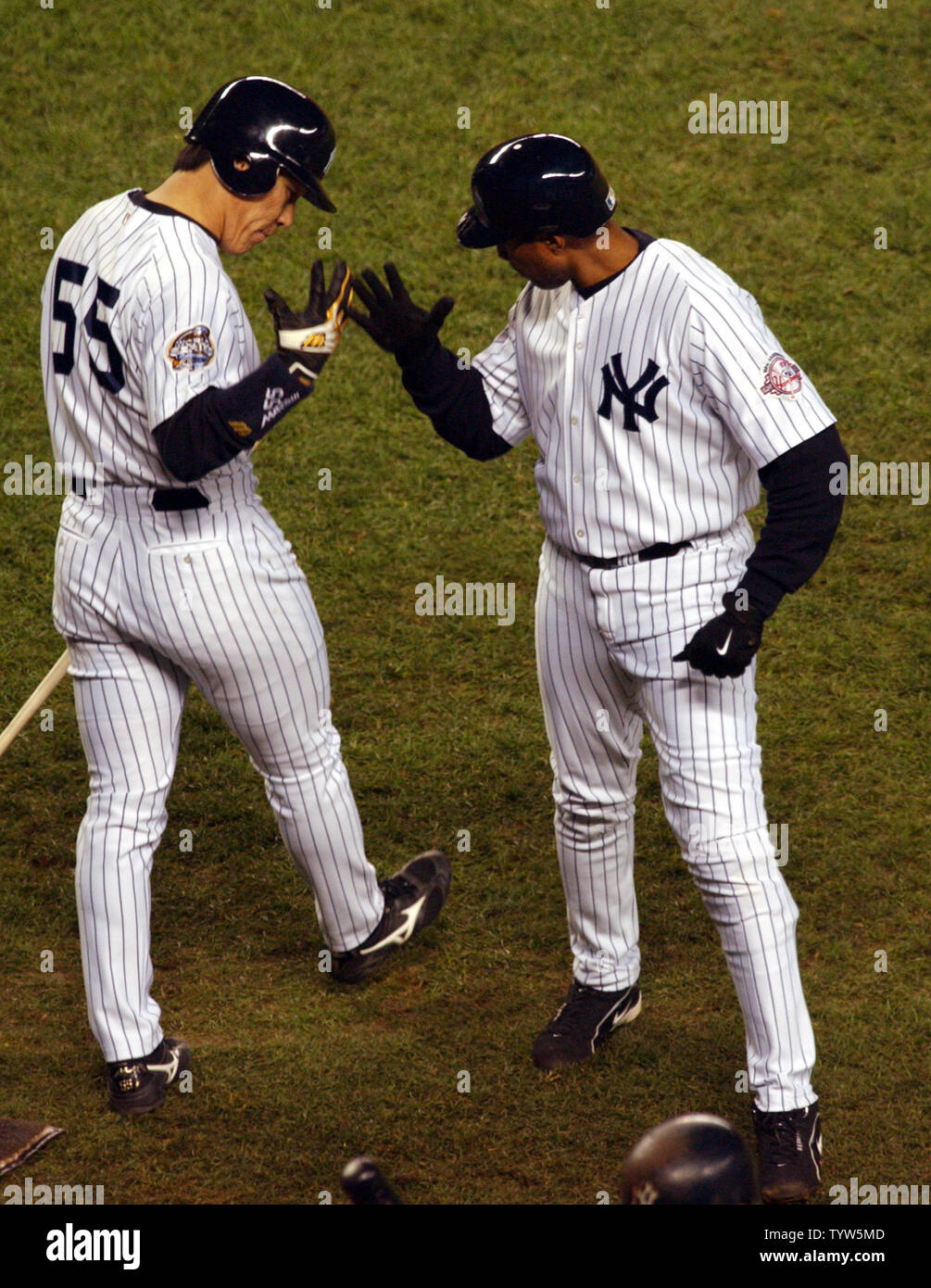 The New York Yankees' Bernie Williams, right, is congratulated by team mate Hideki Matsui after Williams hit a solo home run in the sixth inning against the Florida Marlins in Game 1 of the World Series at Yankee Stadium on October 18, 2003. The Marlins won 3-2.  (UPI/Roger L. Wollenberg) Stock Photo