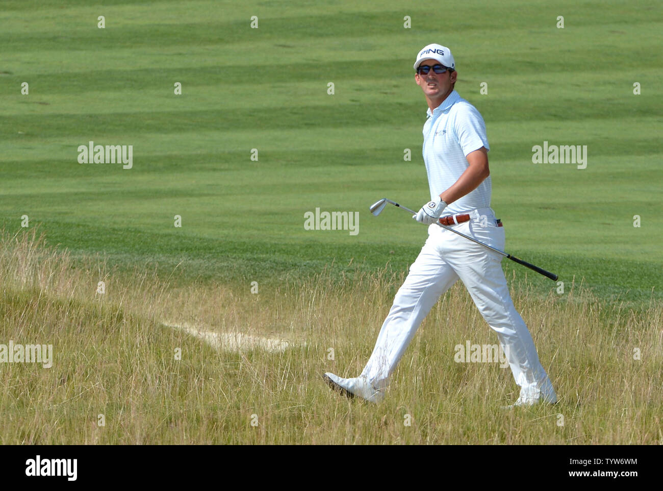Andrew Landry looks at his ball after he hits a shot from around the