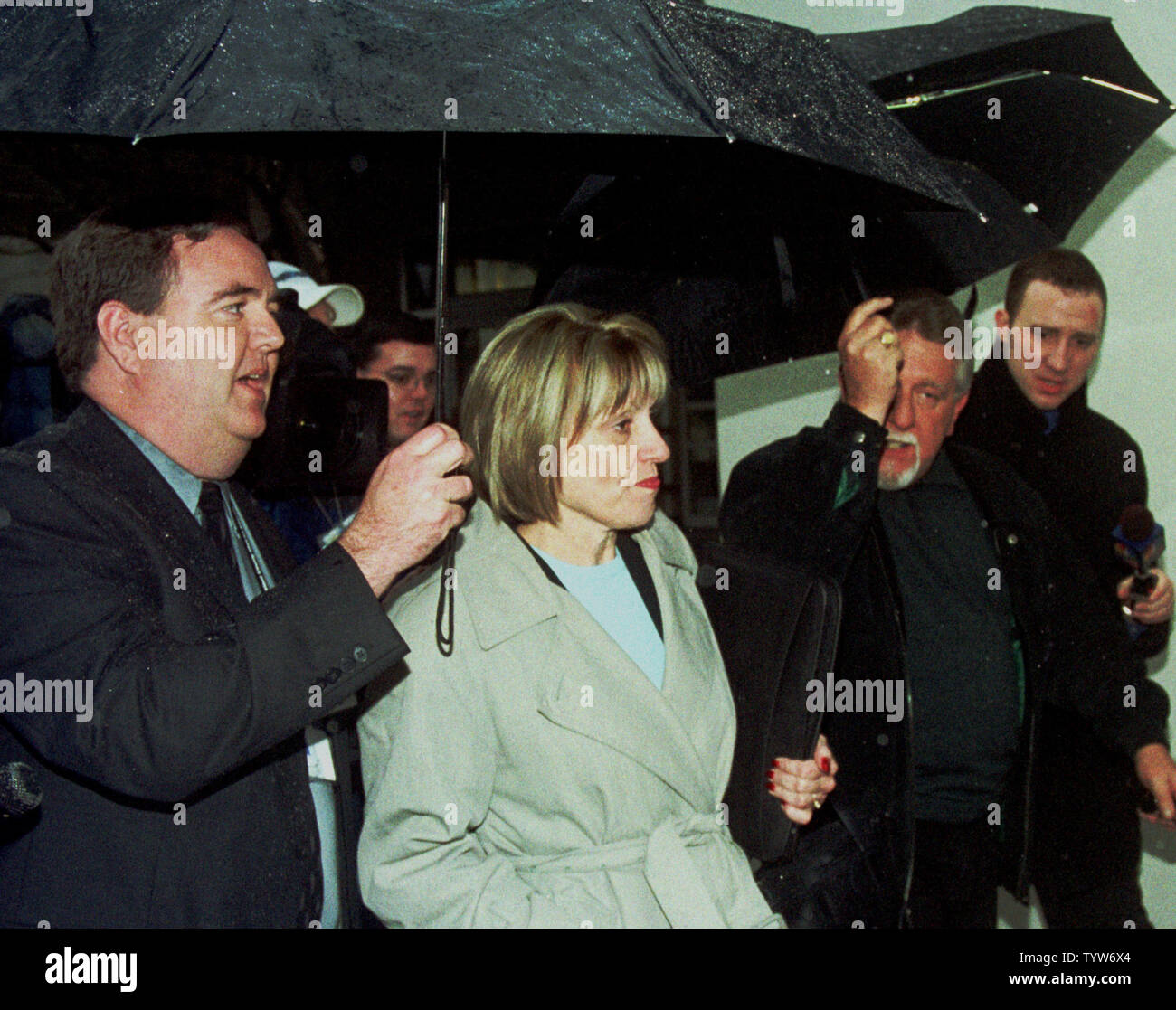 Sharon Rocha, center, leaves the San Mateo County Courthouse in Redwood City, Calif., on February 2, 2004, after a hearing for her son-in-law Scott Peterson, who is accused of murdering her daughter Laci Peterson and their unborn son. Accompanying her is her husband, Ron Grantski, second from right. (UPI Photo/David Yee) Stock Photo