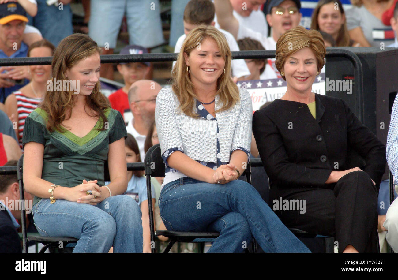 The Bush girls, from left, Barbara, Jenna, and Laura, share a moment during the President's speach at a campaign rally in Kirtland, Ohio, on Sept 4,2004.  About 22,000 turned out for the rally in spite of heavy rains.  (UPI Photo/Michael WIlliams) Stock Photo