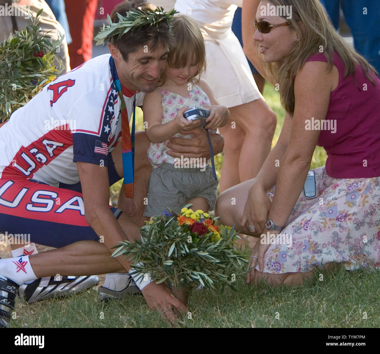 The USA's Bobby Julich shares a moment with his wife Angela and daughter Olivia after winning bronze in the men's cycling Individual Road Time Trial final at the 2004 Athens Summer Olympic Games, August 18, 2004.   (UPI /  Heinz Ruckemann) Stock Photo