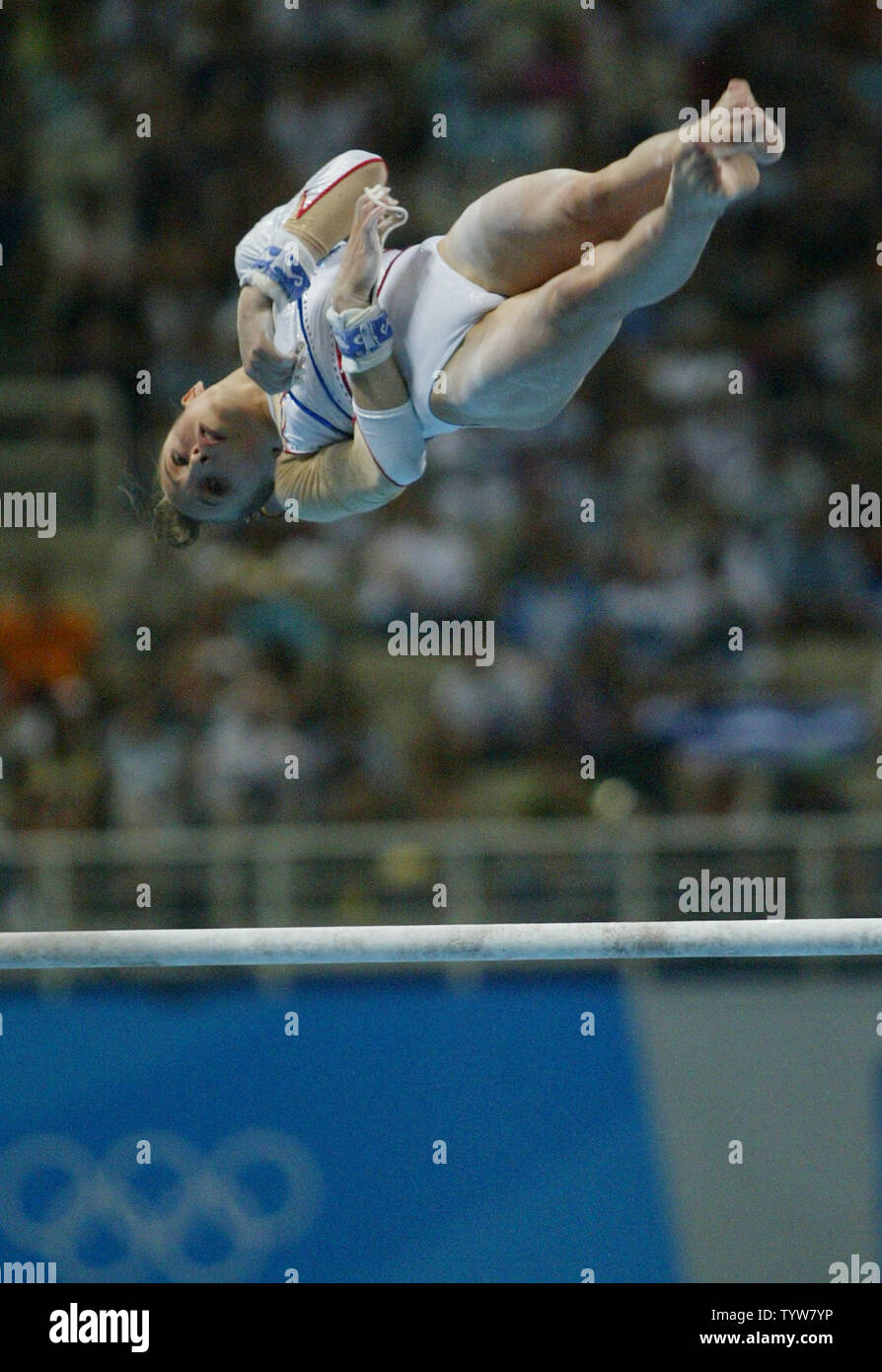 French Gymnast Emilie Lepennec Performs A Def A 1 1 2 Twisting Back Somersault Release En Route To Winning The Gold Medal In The Uneven Bars Final At The Athens Olympic Indoor Hall On