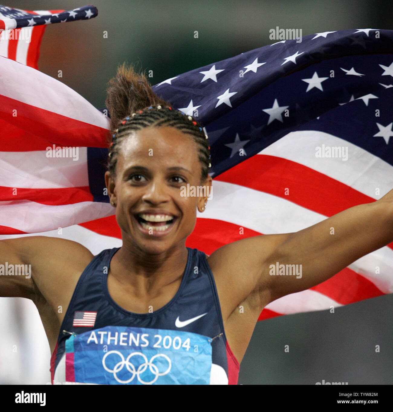 American hurdler Joanna Hayes takes a victory lap after capturing the