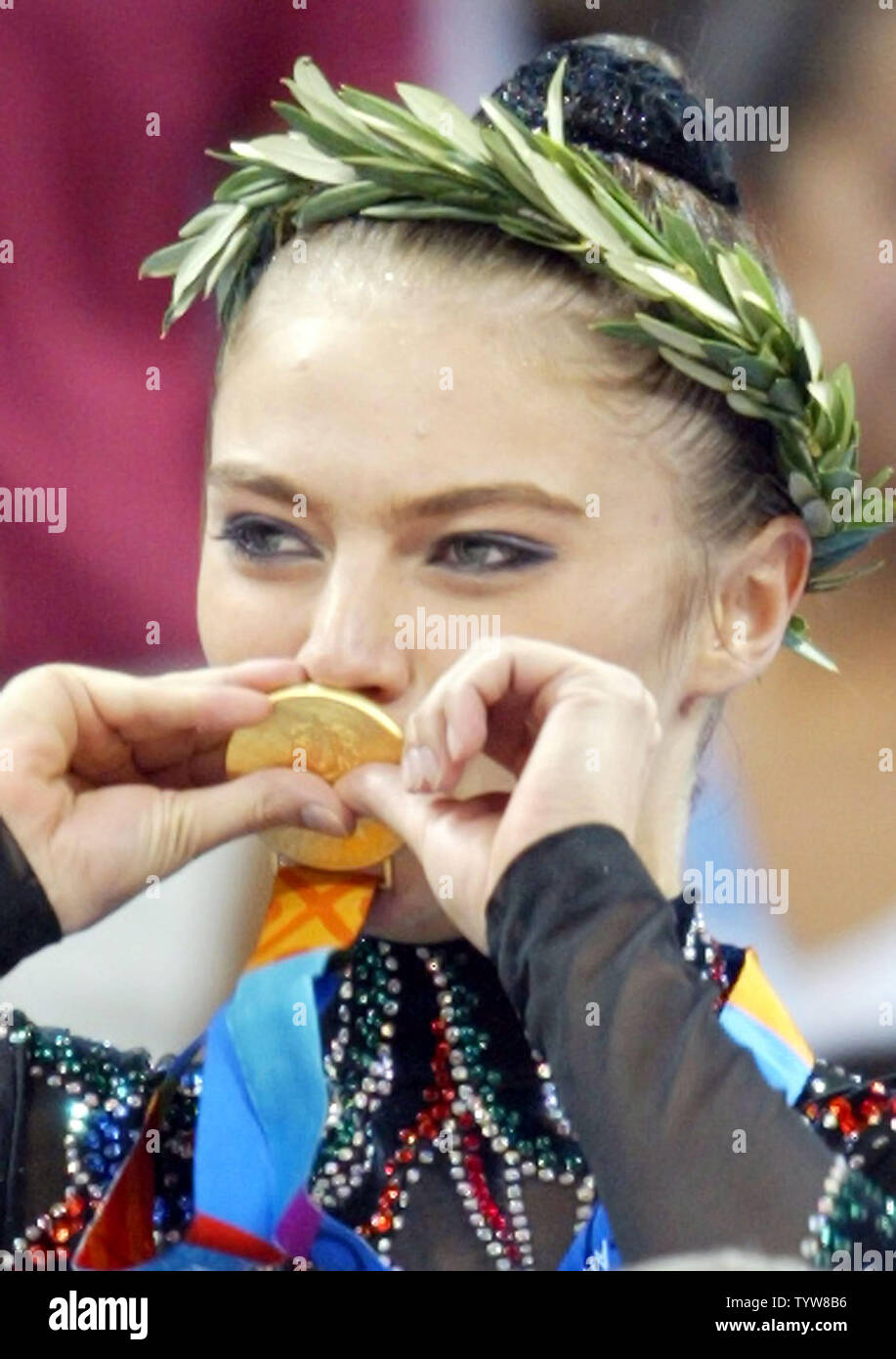 Alina Kabaeva of Russia kisses her gold medal after winning the rhythmic gymnastics individual all around final at the Athens Galatsi Hall on August 29, 2004. Kabaeva finished the four-apparatus event with a total of 108.400 points.  (UPI Photo/Grace Chiu) Stock Photo