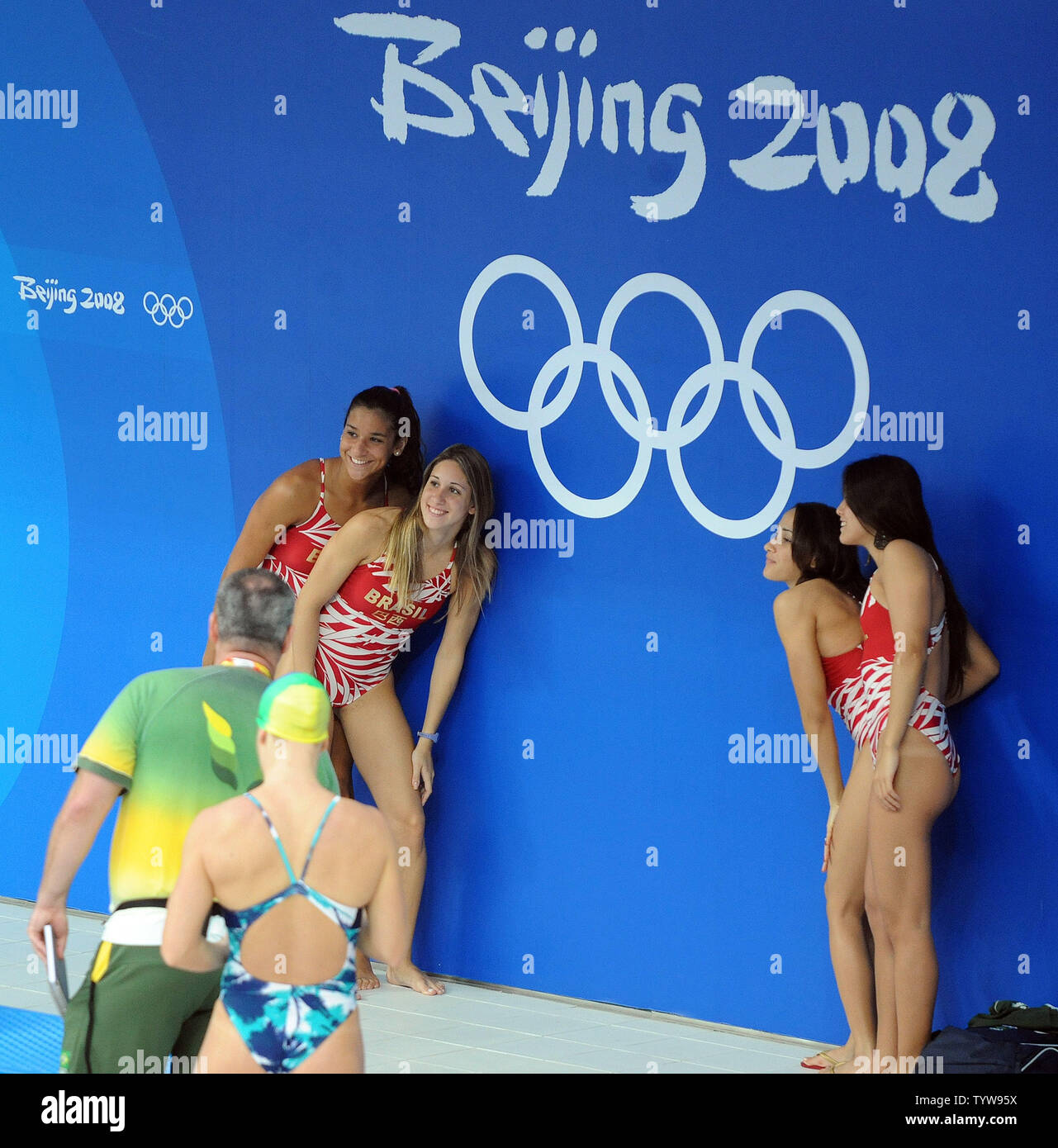 Members of the Brazilian swim team pose for a photo under an Olympic logo before they practice at the National Aquatic Center, known as the Water Cube, in Beijing, China, on August 5, 2008. The 2008 Summer Olympics Opening Ceremony will be on August 8.      (UPI Photo/Roger L. Wollenberg) Stock Photo