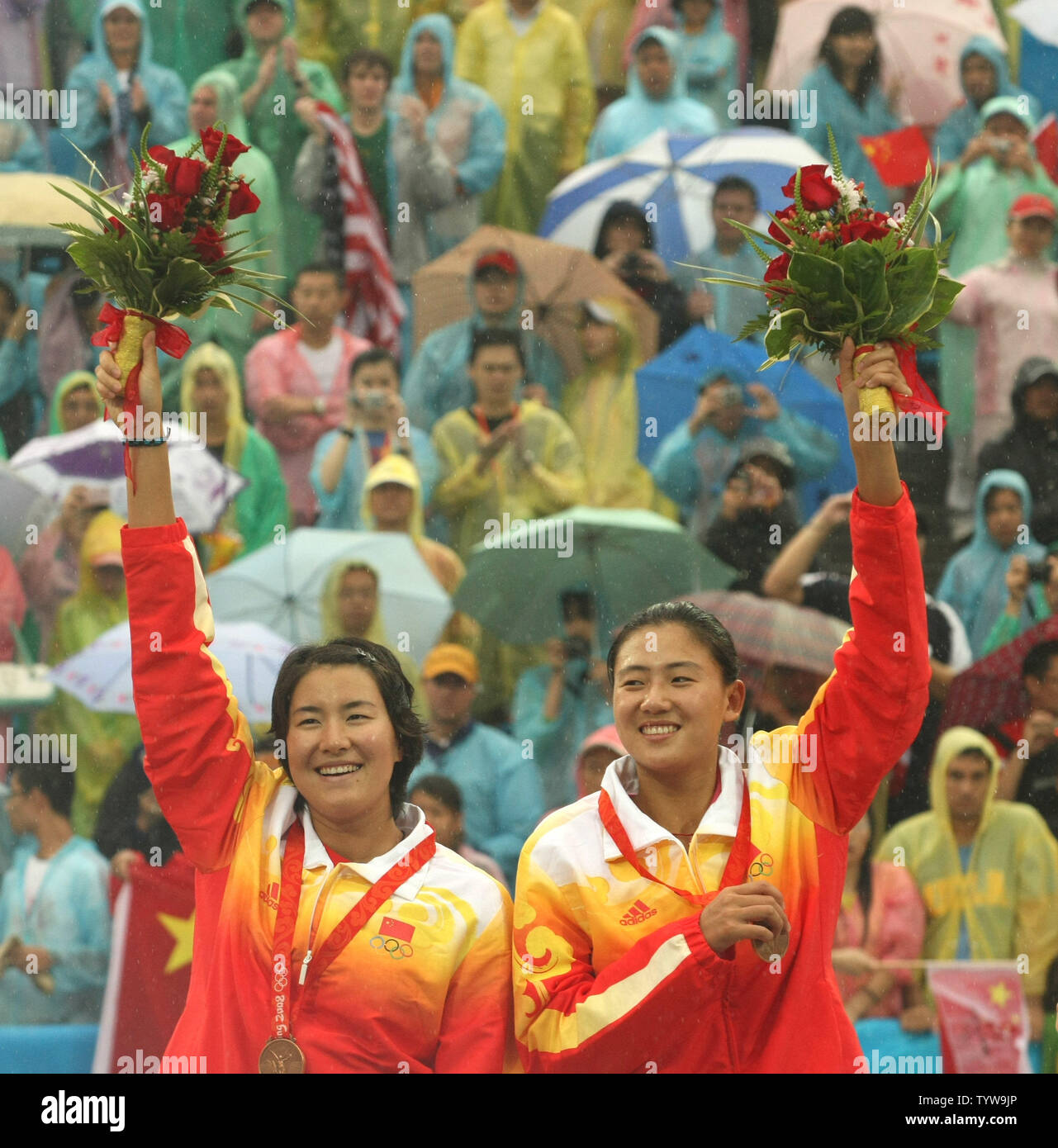 Bronze medalists China's Xue Chen and Zhang Xi salute the crowd during ...