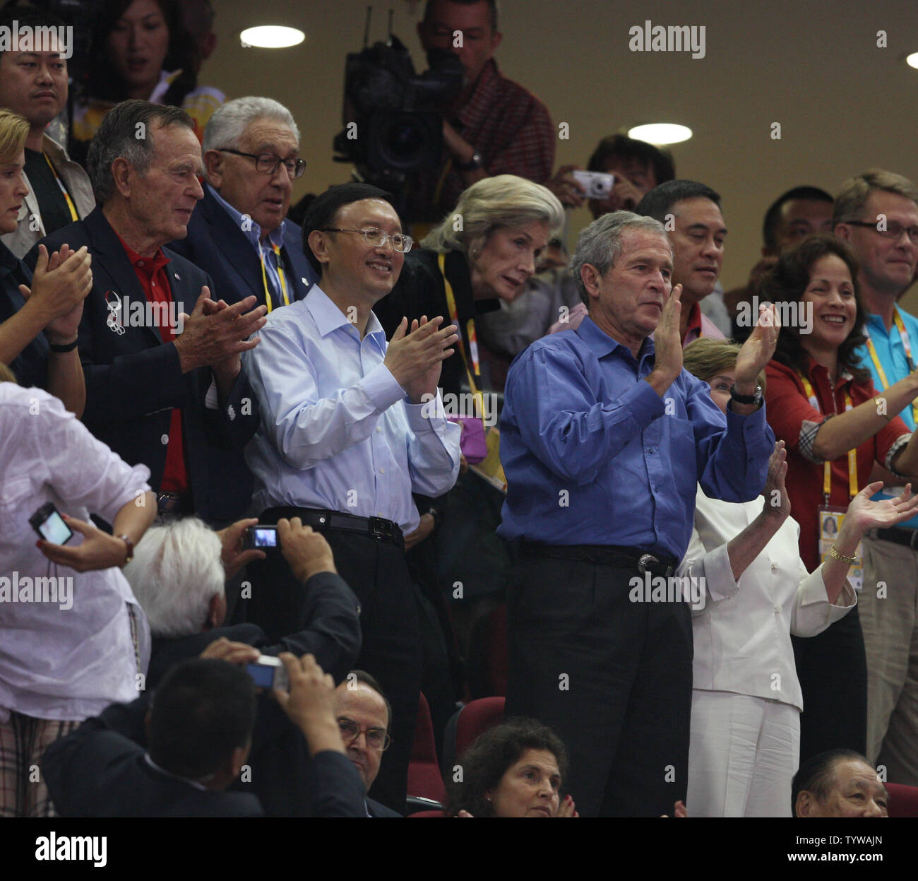 Former President Bush, Henry Kissinger, Chinese Foreign Minister Yang Jiechi and President George Bush applaud as the USA basketball team enters to play China at the 2008 Olympics in Beijing on August 10, 2008.  (UPI Photo/Terry Schmitt) Stock Photo