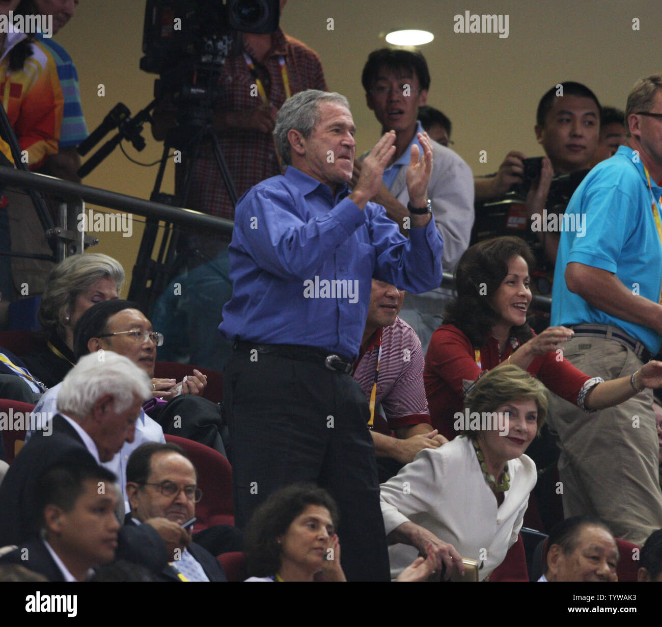 President George Bush applaud and whistles as the USA basketball team enters to play China at the 2008 Olympics in Beijing on August 10, 2008.  (UPI Photo/Terry Schmitt) Stock Photo