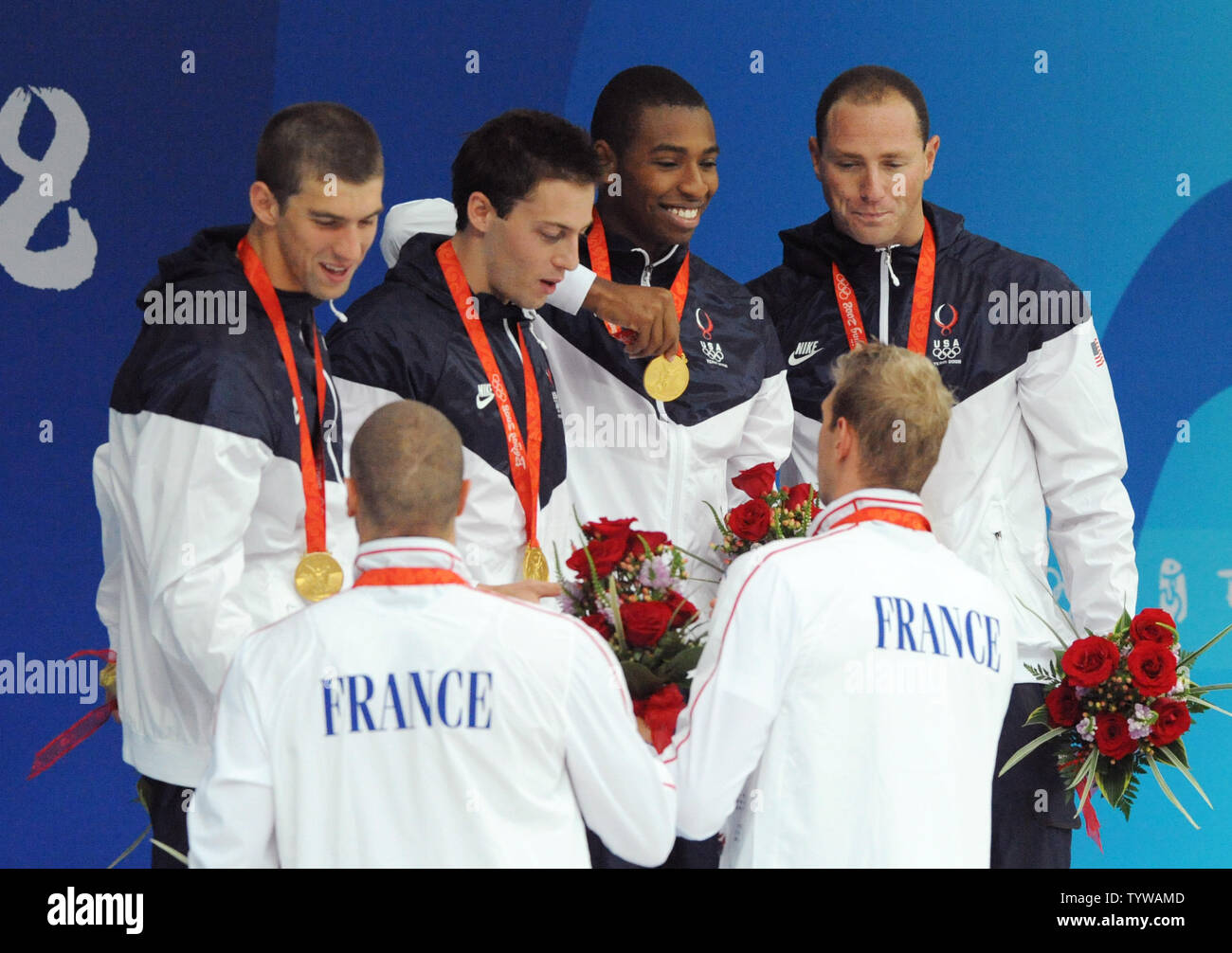 The French 4x100M Relay team congratulates the USA's gold medal team of (L-R) Michael Phelps, Garrett Weber-Gale, Cullen Jones and Jason Lezak during the awards ceremony at the National Aquatics Center at the Summer Olympics in Beijing on August 11, 2008.  The United States team won the gold in a World Record time of 3:08.24, nipping the French team by 0.07 second.    (UPI Photo/Pat Benic) Stock Photo