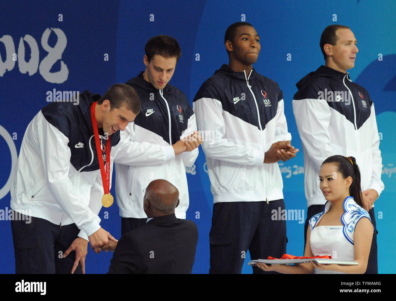 USA's Michael Phelps receives his second gold medal of the Olympics as his Men's 4x100M Relay team members, Garret Weber-Gale, Cullen Jones and Jason Lezak look on during the awards ceremonies at the National Aquatics Center at the Summer Olympics in Beijing on August 11, 2008.  The United States team won the gold in a World Record time of 3:08.24.    (UPI Photo/Pat Benic)l Stock Photo