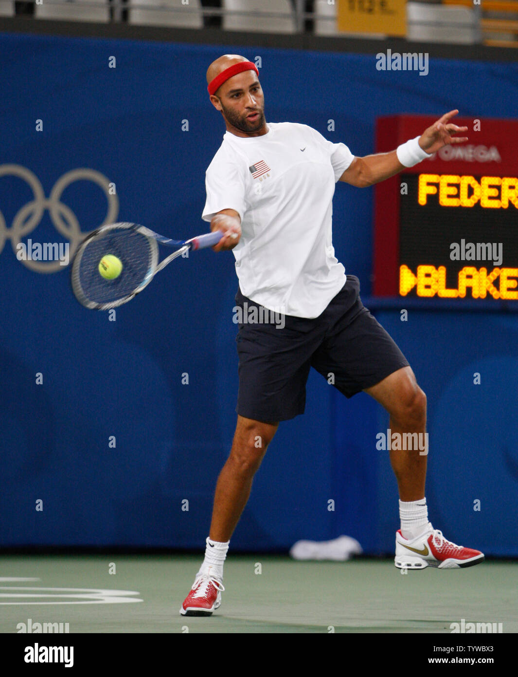 James Blake of the United States returns a volley to Roger Federer of Switzerland in the quarterfinals of men's tennis at the 2008 Olympics in Beijing on August 14, 2008. The quarterfinals had a 4 hour rain delay. Blake upset the number one seed Federer 6-4, 7-6 (2).   (UPI Photo/Terry Schmitt) Stock Photo