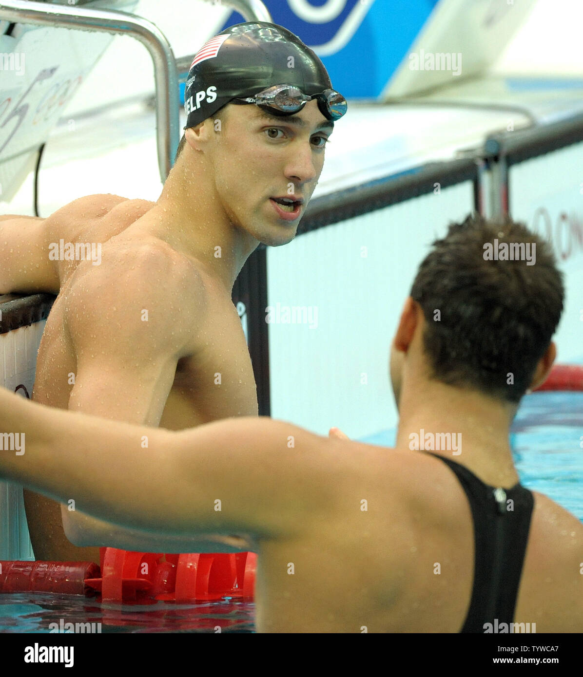 USA's Michael Phelps (L) shakes hands with Serbia's Milorad Cavic after the Men's 100M Butterfly final at the National Aquatic Center (Water Cube) during the 2008 Summer Olympics in Beijing, China, on August 16, 2008. Phelps won gold, Milorad silver. Phelps is tied with Mark Spitz, the swimmer who set the record for 7 gold medals in a single Olympics in Munich, 1972.  (UPI Photo/Roger L. Wollenberg) Stock Photo