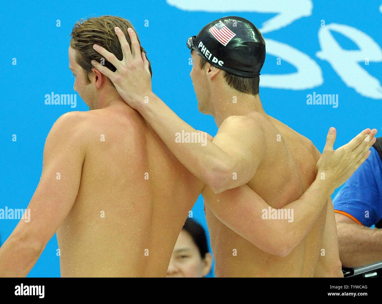 USA's Michael Phelps walks off the pool deck with team mate Ian Crocker after Phelps picked up his 7th gold medal in the Men's 100M Butterfly final at the National Aquatic Center (Water Cube) during the 2008 Summer Olympics in Beijing, China, on August 16, 2008. Phelps is tied with Mark Spitz, the swimmer who set the record for 7 gold medals in a single Olympics in Munich, 1972. Crocker finished 4th in the race.  (UPI Photo/Roger L. Wollenberg) Stock Photo