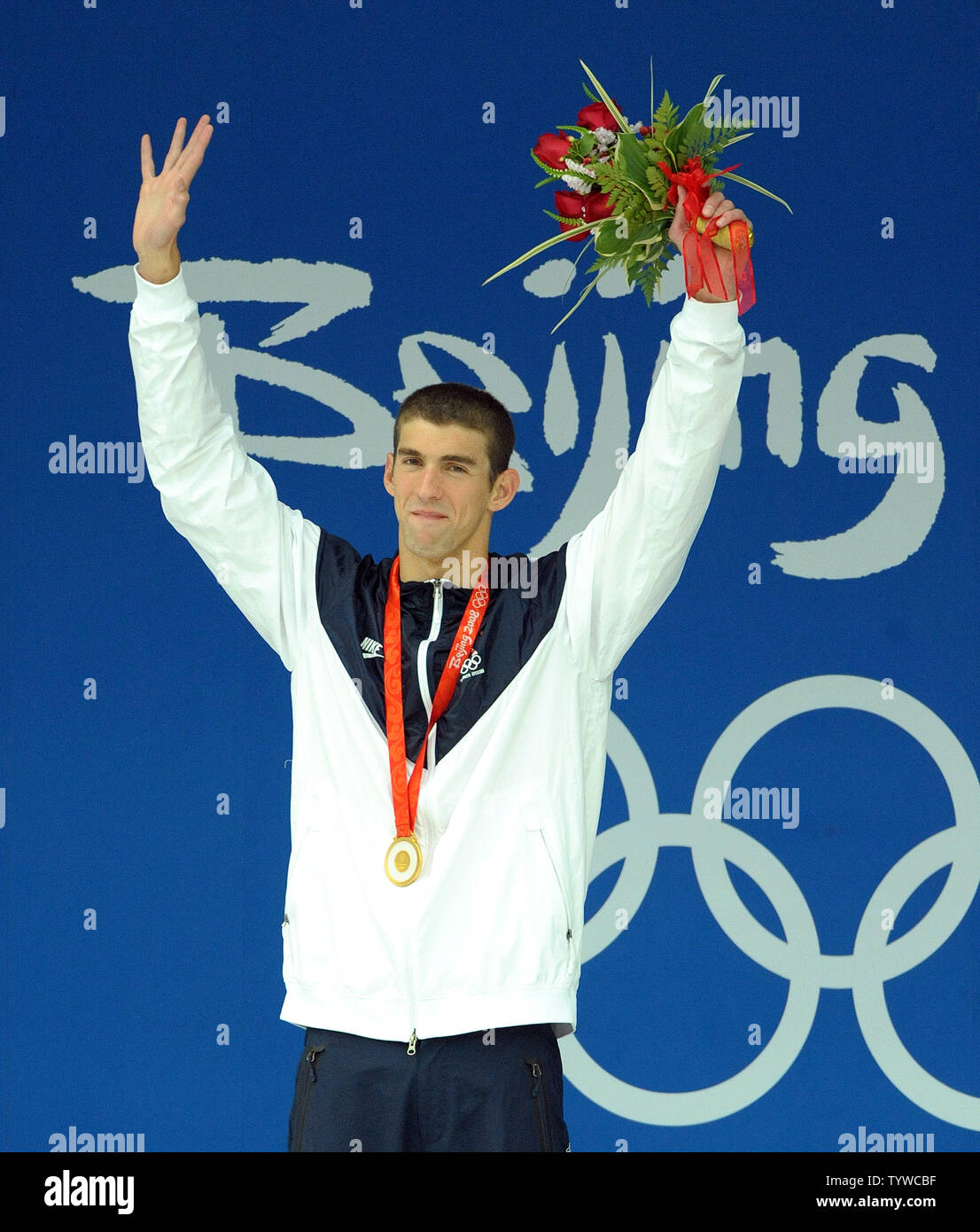 USA's Michael Phelps raises his arms after receiving his 7th gold medal for the Men's 100M Butterfly final at the National Aquatic Center (Water Cube) during the 2008 Summer Olympics in Beijing, China, on August 16, 2008. Phelps is tied with Mark Spitz, the swimmer who set the record for 7 gold medals in a single Olympics in Munich, 1972.   (UPI Photo/Roger L. Wollenberg) Stock Photo