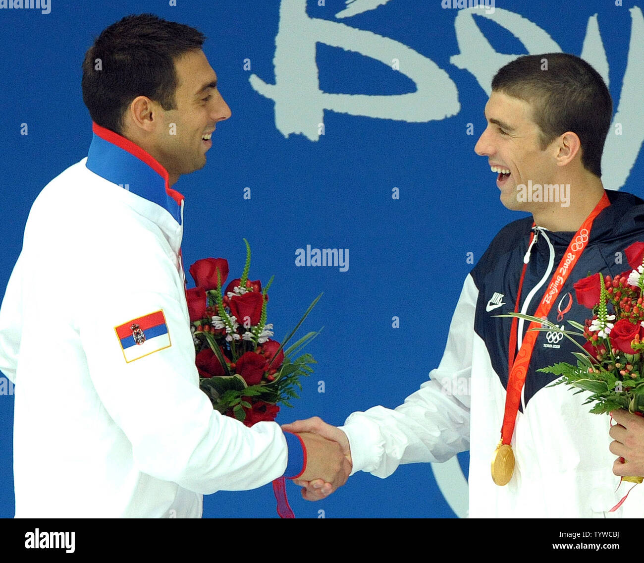 USA's Michael Phelps (gold) shakes hands with Serbia's Milorad Cavic (silver) (R) after they received their medals for the Men's 100M Butterfly final at the National Aquatic Center (Water Cube) during the 2008 Summer Olympics in Beijing, China, on August 16, 2008. Phelps is tied with Mark Spitz, the swimmer who set the record of 7 gold medals in a single Olympics in Munich, 1972.   (UPI Photo/Roger L. Wollenberg) Stock Photo