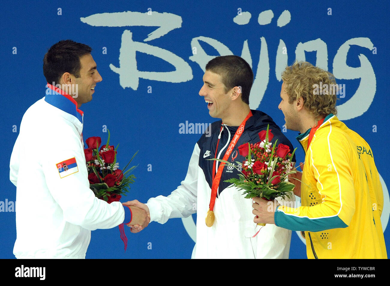 USA's Michael Phelps (gold) (C) shakes hands with Serbia's Milorad Cavic (silver) (L) as Australia's Andrew Lauterstein (bronze) looks on after they received their medals for the Men's 100M Butterfly final at the National Aquatic Center (Water Cube) during the 2008 Summer Olympics in Beijing, China, on August 16, 2008. Phelps is tied with Mark Spitz, the swimmer who set the record of 7 gold medals in a single Olympics in Munich, 1972.   (UPI Photo/Roger L. Wollenberg) Stock Photo