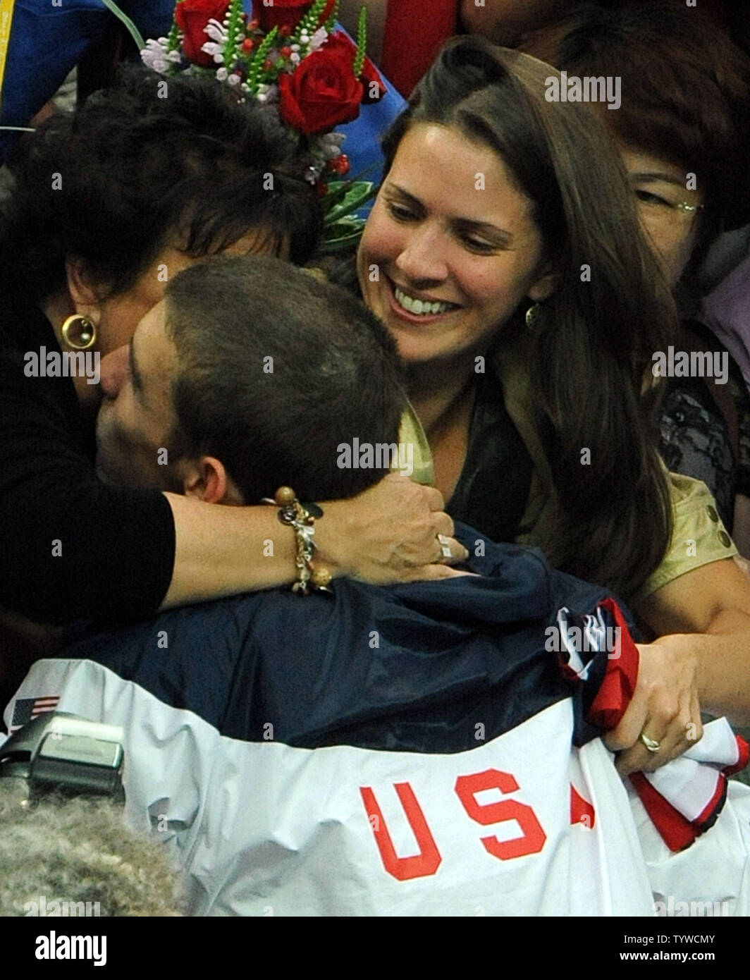 USA's Michael Phelps is congratulated by his mother and sister after the US team received their medals for the Men's 4x100M Medley, setting a world record of 3:29.34, at the National Aquatic Center (Water Cube) during the 2008 Summer Olympics in Beijing, China, on August 17, 2008.  Phelps set the world record for medals in a single Olympics with 8, passing Mark Spitz.    (UPI Photo/Roger L. Wollenberg) Stock Photo