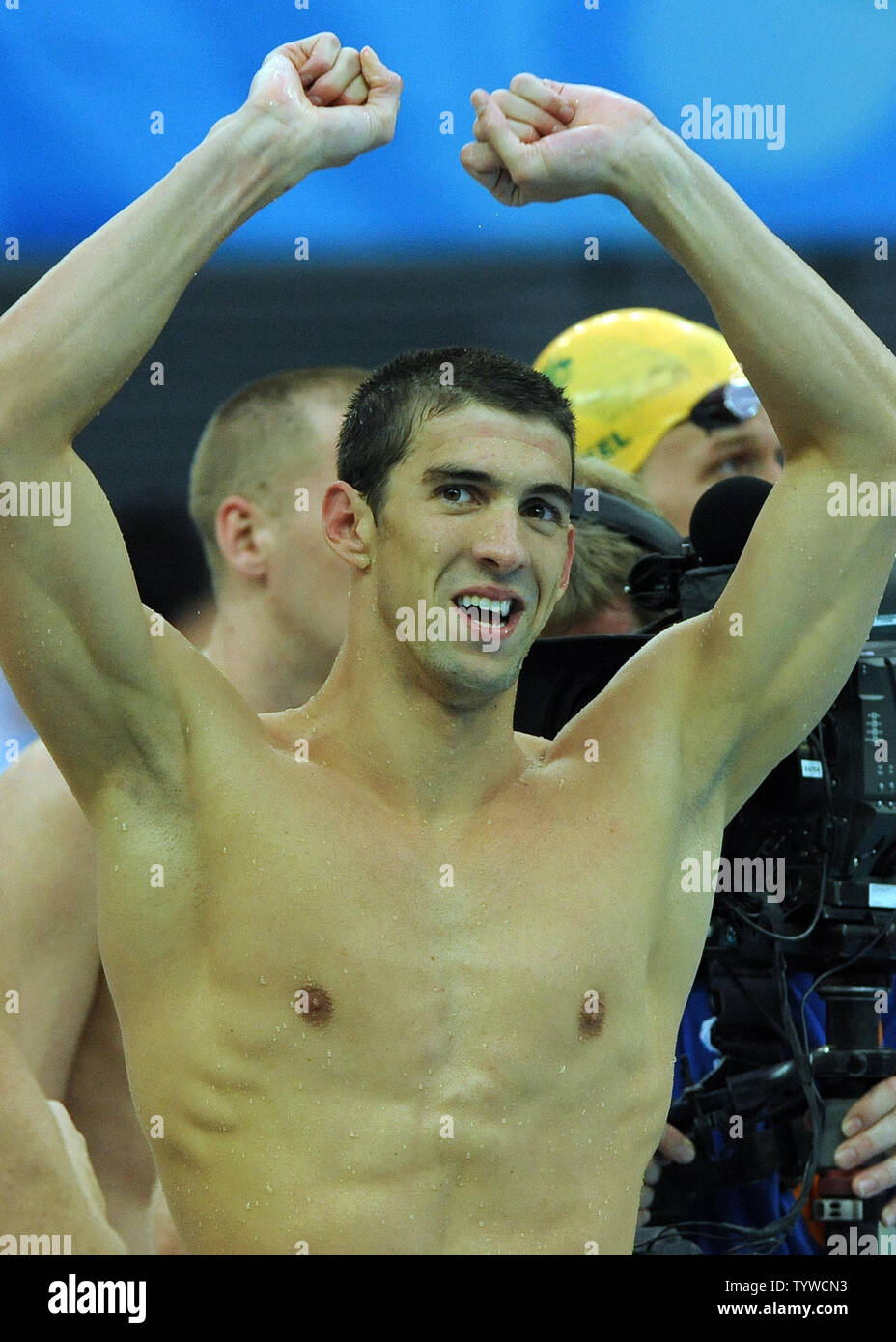 USA's Michael Phelps raises his arms in victory after the US team wins gold in the Men's 4x100M,  setting a world record, at the National Aquatic Center (Water Cube) during the 2008 Summer Olympics in Beijing, China, on August 17, 2008.  Phelps set the world record for medals in a single Olympics with 8, passing Mark Spitz.    (UPI Photo/Roger L. Wollenberg) Stock Photo