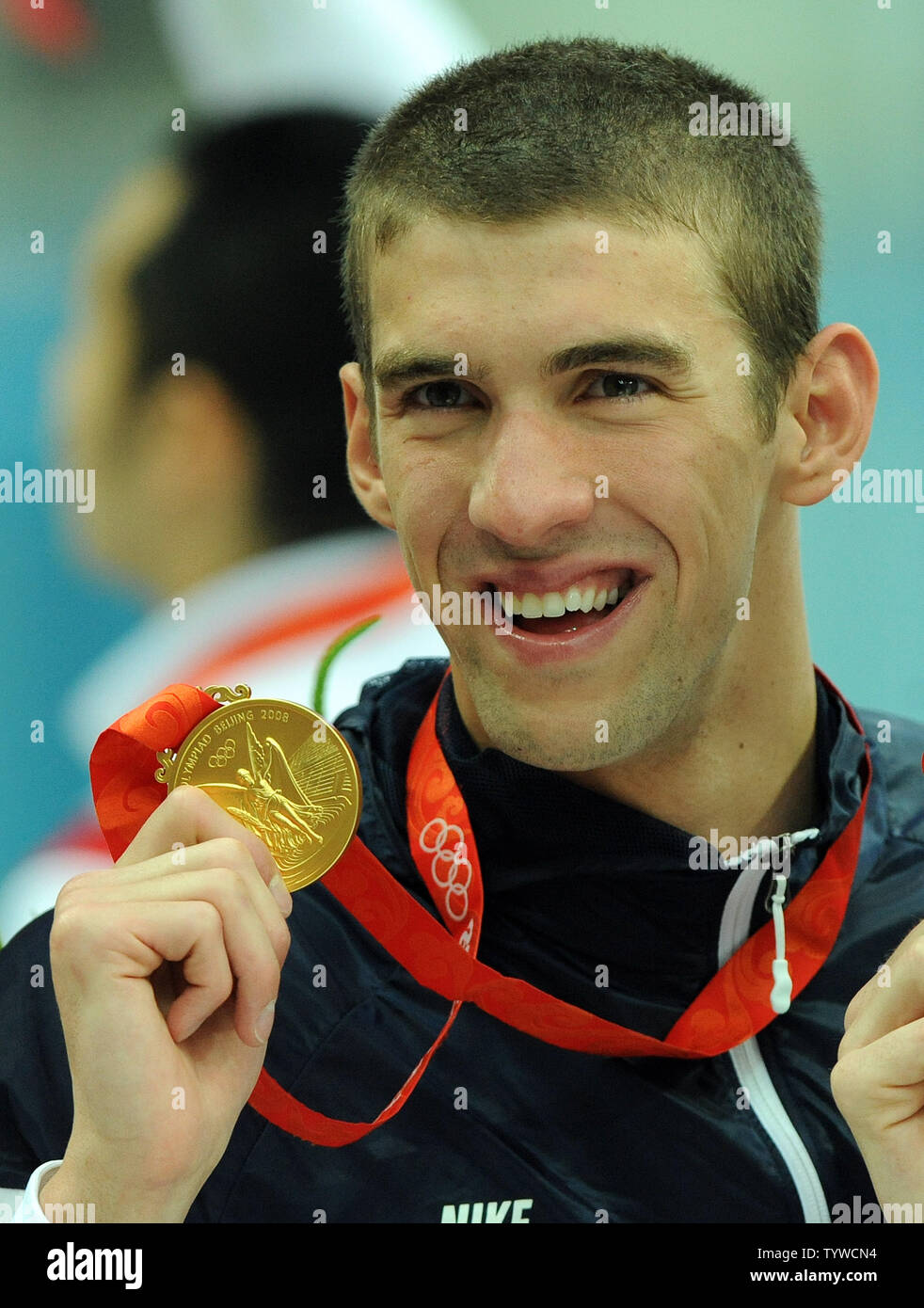 USA's Michael Phelps holds up his eight medal afte the US team wins gold in the Men's 4x100M,  setting a world record, at the National Aquatic Center (Water Cube) during the 2008 Summer Olympics in Beijing, China, on August 17, 2008.  Phelps set the world record for medals in a single Olympics with 8, passing Mark Spitz.    (UPI Photo/Roger L. Wollenberg) Stock Photo