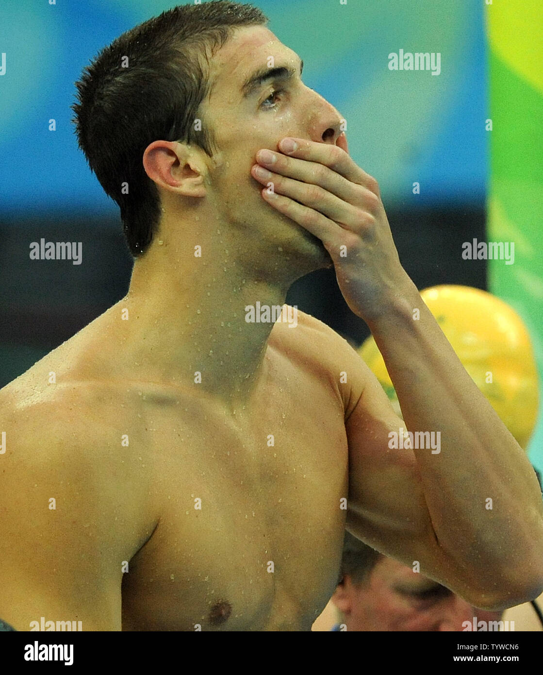 USA's Michael Phelps covers his mouth as the US team wins gold in the Men's 4x100M,  setting a world record, at the National Aquatic Center (Water Cube) during the 2008 Summer Olympics in Beijing, China, on August 17, 2008.  Phelps set the world record for medals in a single Olympics with 8, passing Mark Spitz.    (UPI Photo/Roger L. Wollenberg) Stock Photo