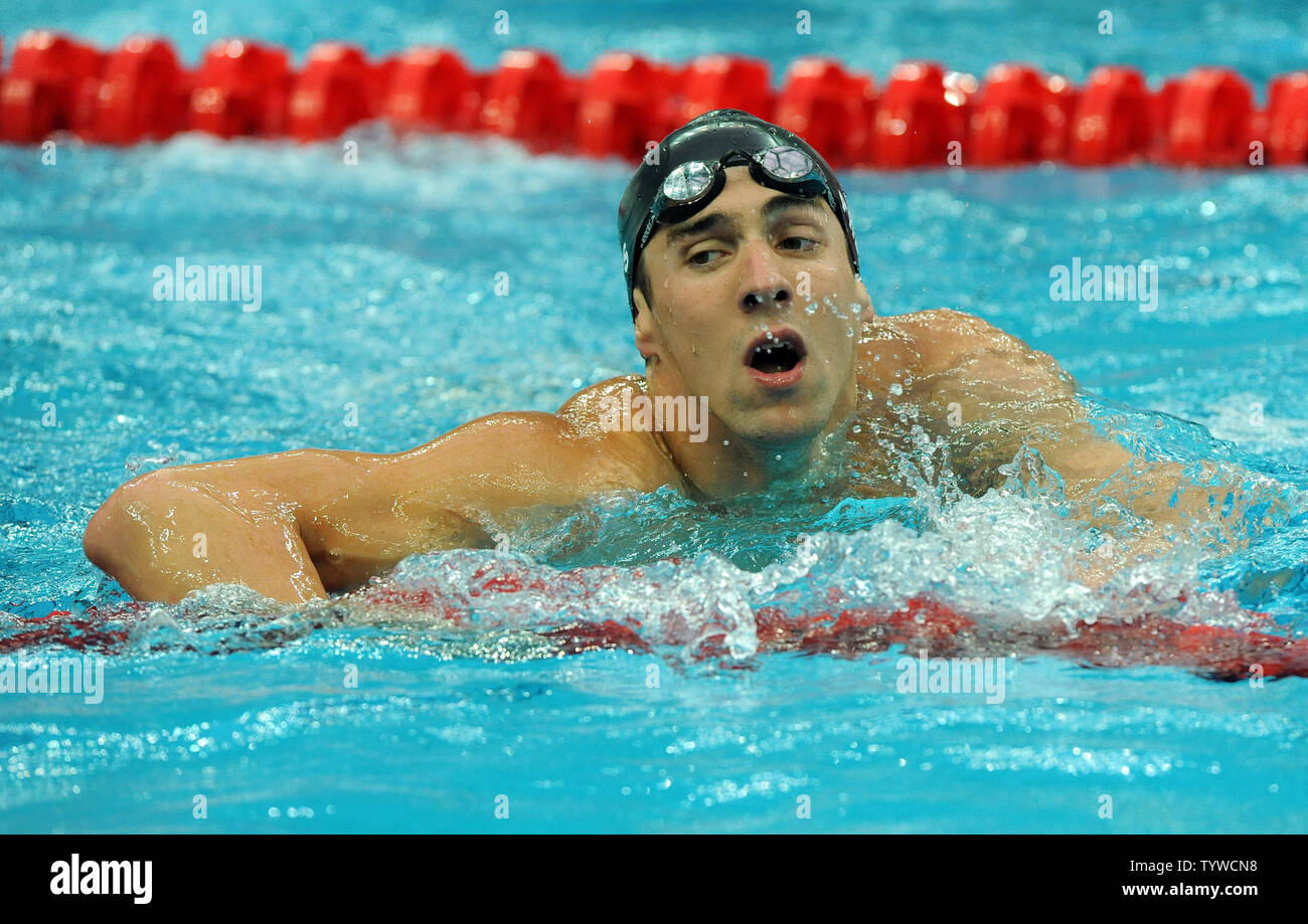 USA's Michael Phelps struggles out of the water after swimming the Butterfly part of the Men's 4x100M, helping the US team set a world record and win gold, at the National Aquatic Center (Water Cube) during the 2008 Summer Olympics in Beijing, China, on August 17, 2008.  Phelps set the world record for medals in a single Olympics with 8, passing Mark Spitz.    (UPI Photo/Roger L. Wollenberg) Stock Photo