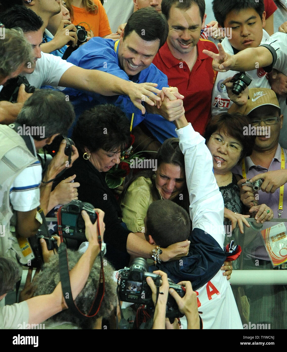 USA's Michael Phelps is congratulated by his mother, sister and others in the stands after the US team received their medals for the Men's 4x100M Medley, setting a world record of 3:29.34, at the National Aquatic Center (Water Cube) during the 2008 Summer Olympics in Beijing, China, on August 17, 2008.  Phelps set the world record for medals in a single Olympics with 8, passing Mark Spitz.    (UPI Photo/Roger L. Wollenberg) Stock Photo