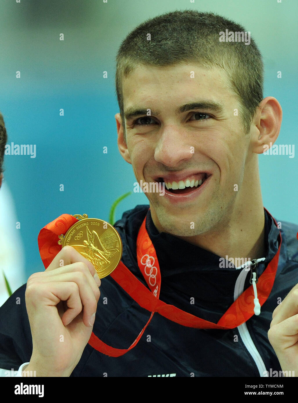 USA's Michael Phelps shows his medal for his part in the Men's 4x100M Medley, where the US team set a world record and won gold, at the National Aquatic Center (Water Cube) during the 2008 Summer Olympics in Beijing, China, on August 17, 2008.  Phelps set the world record for medals in a single Olympics with 8, passing Mark Spitz.    (UPI Photo/Roger L. Wollenberg) Stock Photo