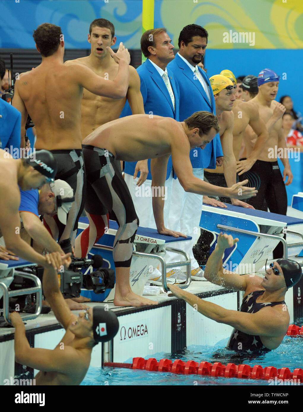 USA's team congratulates each other after winning the Men's 4x100M Medley, setting a world record of 3:29.34, at the National Aquatic Center (Water Cube) during the 2008 Summer Olympics in Beijing, China, on August 17, 2008.  Michael Phelps (top center) moves to shakes hands with Brendan Hansen while Aasron Peirsol leans down to congratulate the final swimmer Jason Lezak. Phelps set the world record for medals in a single Olympics with 8, passing Mark Spitz.    (UPI Photo/Roger L. Wollenberg) Stock Photo