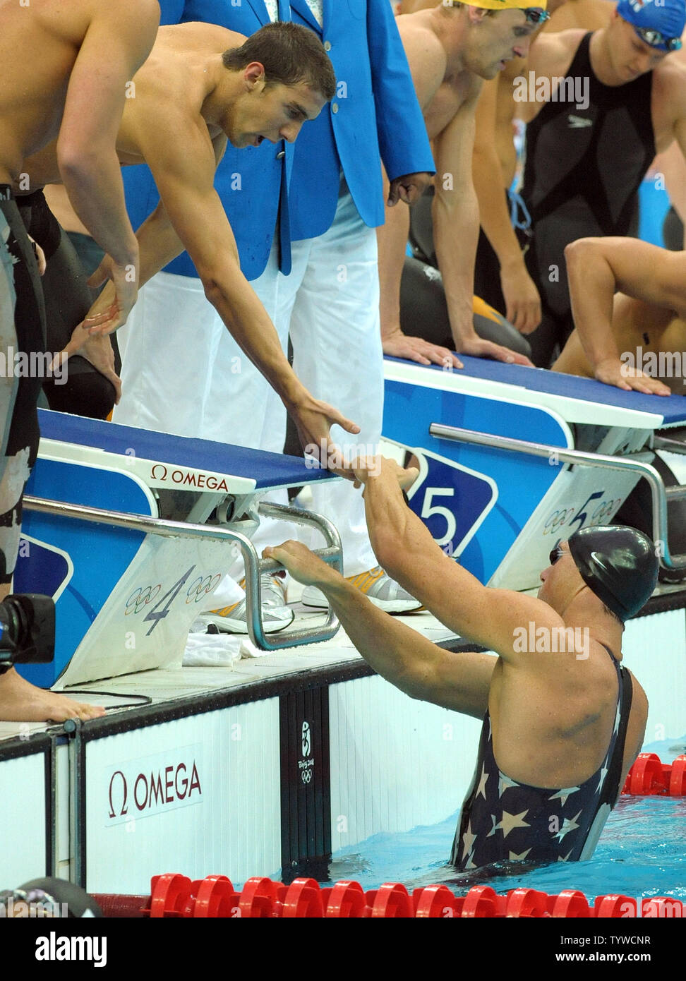 USA's Michael Phelps leans down to shake hands with Jason Lezak after the US team won the Men's 4x100M Medley, setting a world record of 3:29.34, at the National Aquatic Center (Water Cube) during the 2008 Summer Olympics in Beijing, China, on August 17, 2008.  Phelps set the world record for medals in a single Olympics with 8, passing Mark Spitz.    (UPI Photo/Roger L. Wollenberg) Stock Photo