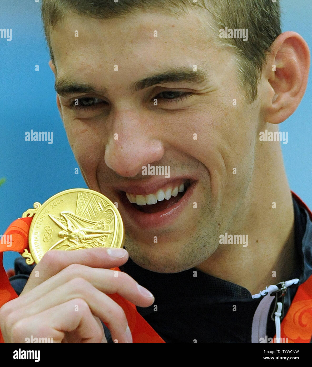 USA's Michael Phelps shows his medal for his part in the Men's 4x100M Medley, where the US team set a world record and won gold, at the National Aquatic Center (Water Cube) during the 2008 Summer Olympics in Beijing, China, on August 17, 2008.  Phelps set the world record for medals in a single Olympics with 8, passing Mark Spitz.    (UPI Photo/Roger L. Wollenberg) Stock Photo