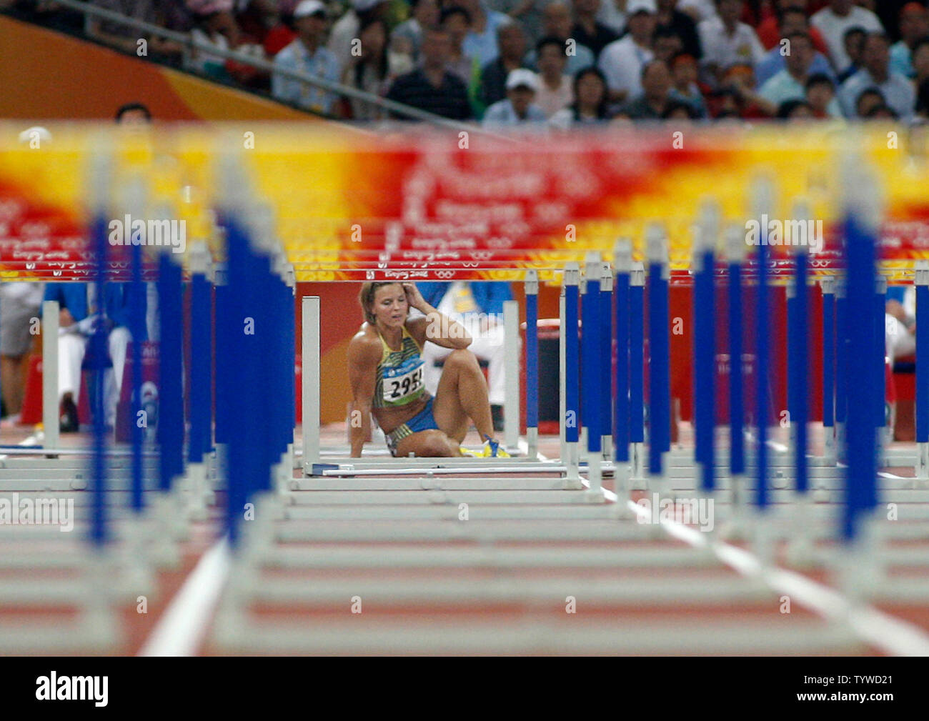 Susanna Kallur of Sweden sits on the track after falling at the beginning of the semifinals of the women's 100m hurdles at the Summer Olympics in Beijing on August 18, 2008. Kallur did not finish.   (UPI Photo/Terry Schmitt) Stock Photo