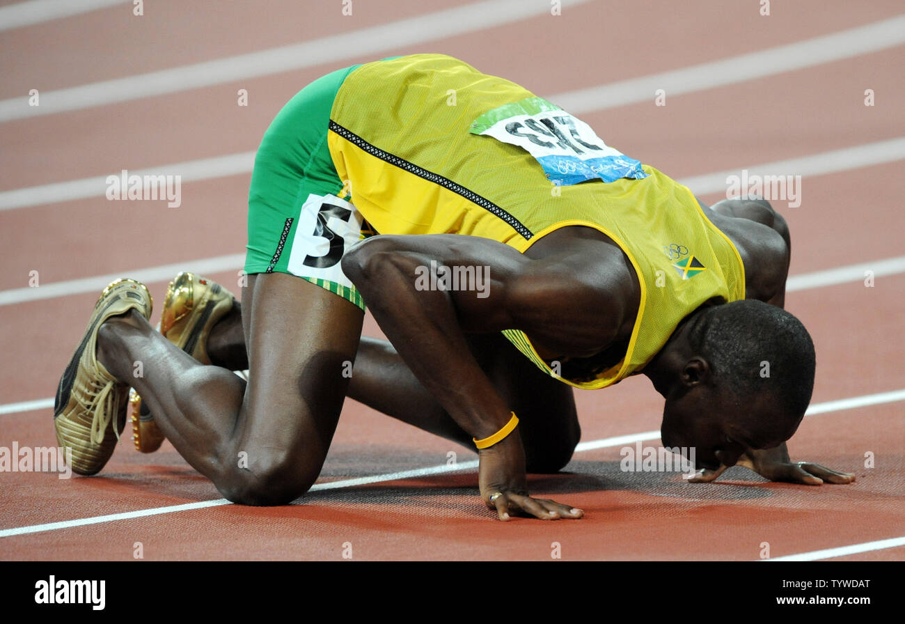 Jamaica's Usian Bolt kisses the track after winning the gold medal and setting a new world record in the Men's 200 meter race at the National Stadium at the Summer Olympics in Beijing on August 20, 2008. Bolt set a new world record of 19.30 seconds, breaking USA's Michael Johnson's record of 19.32 set in 1996.    (UPI Photo/Pat Benic) Stock Photo