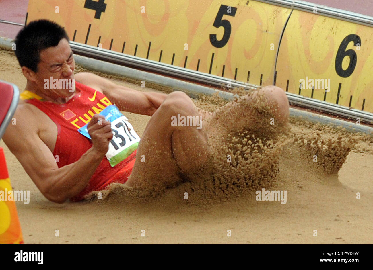 China's Qi Haifeng lands in the sand during the Long Jump part of the ...