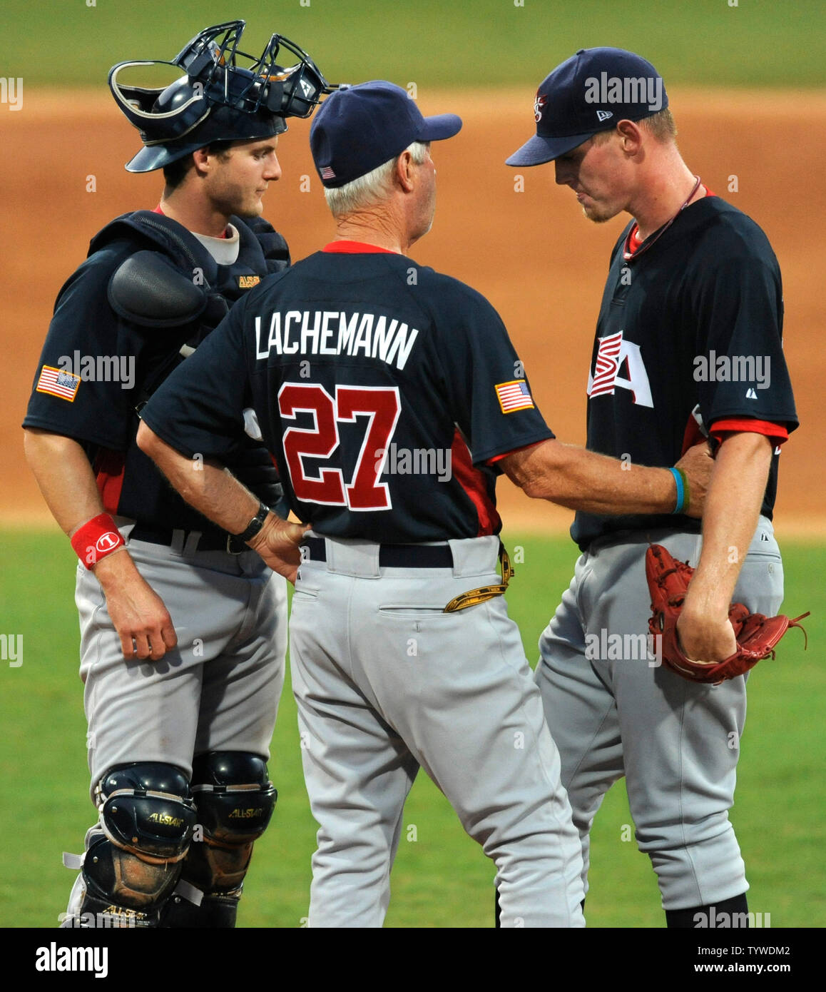USA's pitching coach Marcel Lachemann (C) consoles pitcher Stephen Strasburg (R) during a break in the action against Cuba along with catcher Lou Marson at Wukesong Baseball Field,  August 22, 2008, at the Summer Olympics in Beijing, China.  Cuba beat the USA team 10-2 and will face Korea for the gold medal.       (UPI Photo/Mike Theiler) Stock Photo