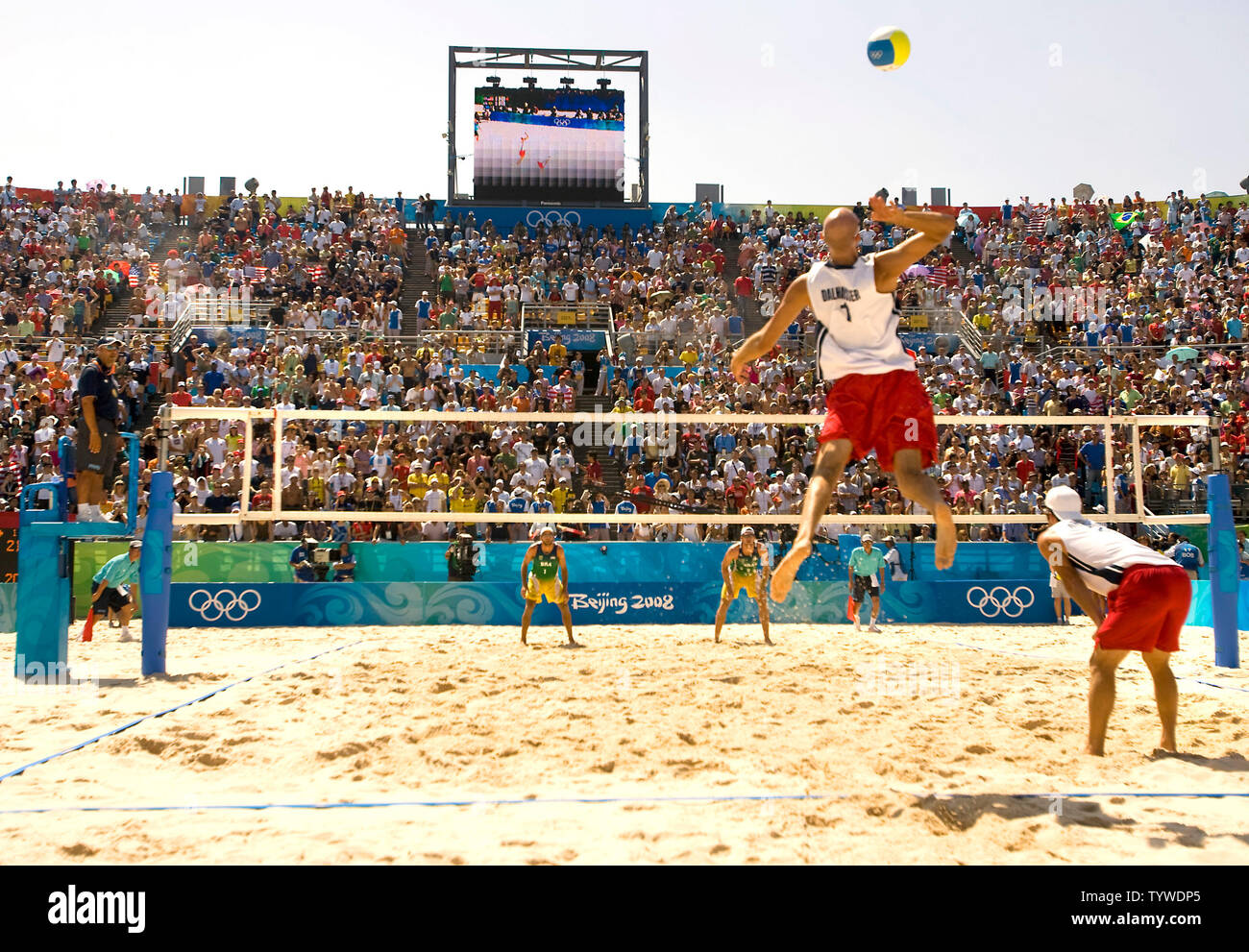 USA's Philip Dalhausser (serving) and Todd Rogers (R) compete in the