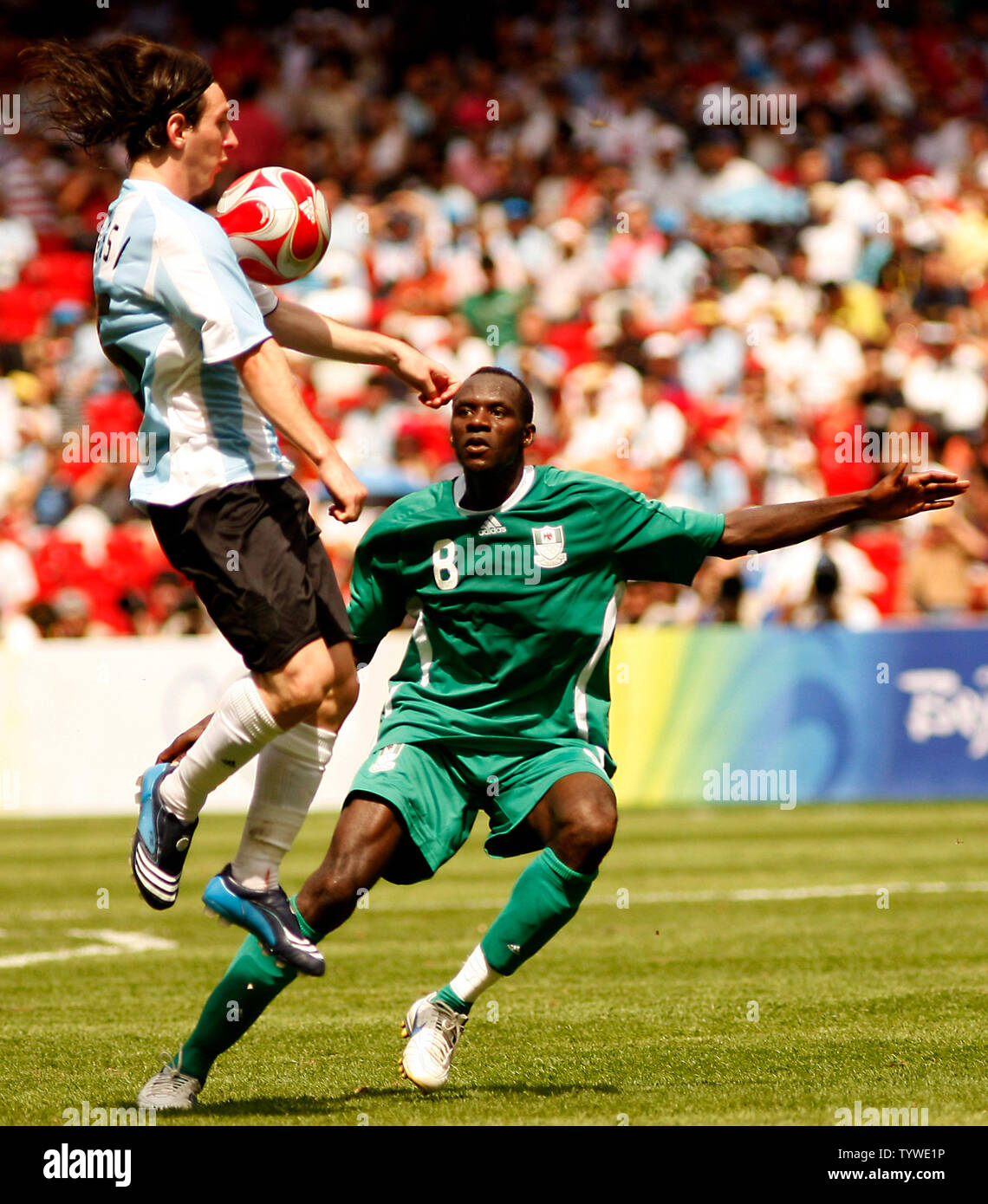 Argentina's Lionel Messi (L) and Nigeria's Sani Kaita fight for the ball during the men's football final in the Beijing 2008 Olympic Games August 23, 2008.  Argentina won 1-0 for the gold, while Nigeria settled for the silver and Brazil the bronze.  (UPI Photo/Stephen Shaver) Stock Photo