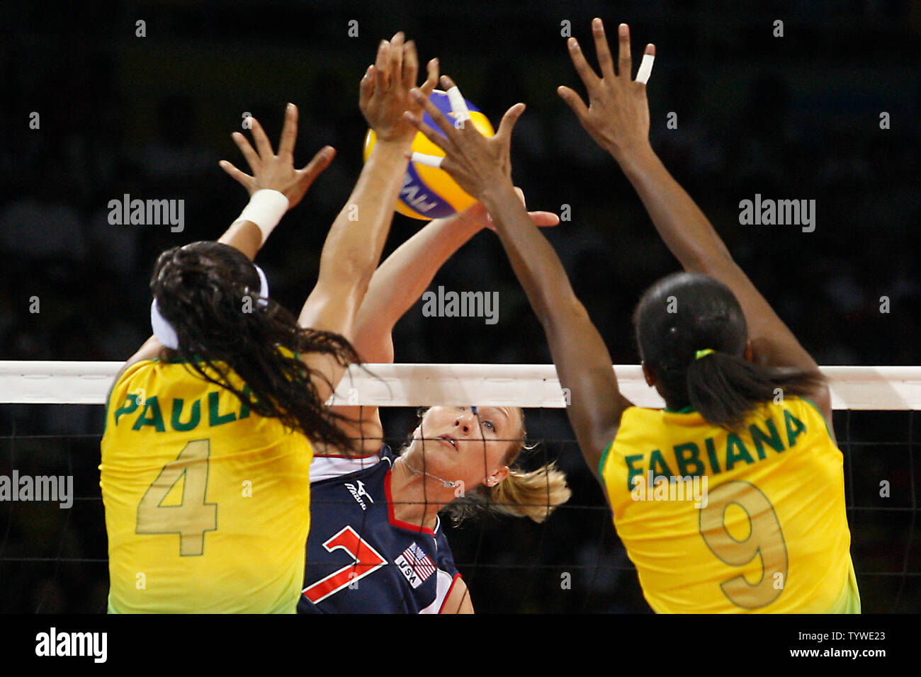 USA's Heather Bown's (C) spike attempt is blocked by Brazil's Paula Pequeno (L) and teammate Fabiana Claudion in the women's volleyball final during the Beijing 2008 Olympic Games August 23, 2008. Brazil won the match 3-1, taking the gold, while USA settled for silver and China the bronze.  (UPI Photo/Stephen Shaver) Stock Photo