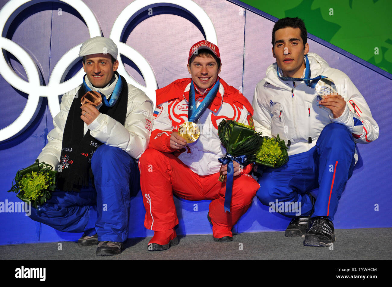 Gold medalist Russia's Evgeny Ustyugov (C), silver medalist France's Martin Fourcade (L) and bronze medalist Slovakia's Pavol Hurajt poses with their medal during the victory ceremony for the Men's Biathlon 15 km Mass Start during the 2010 Vancouver Winter Olympics in Whistler, Canada on February 21, 2010. UPI/Kevin Dietsch Stock Photo