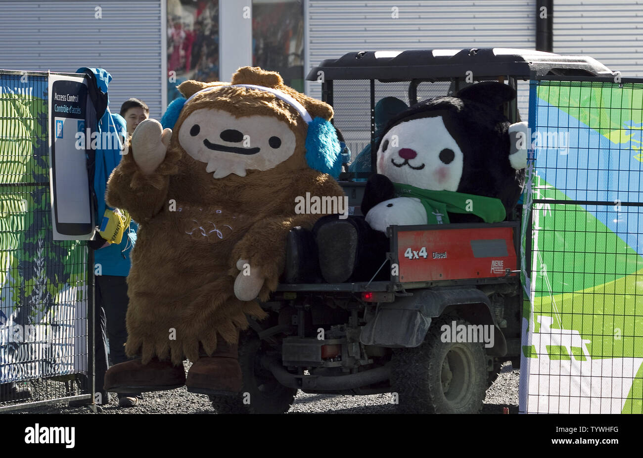 Olympic mascots Quatchi (L.) and Miga hitch a ride on the back of a golf cart as they make the rounds in Biathlon Men's 15 km Mass Start during Vancouver 2010 Winter Olympics at the Whistler Olympic Park in Whistler, British Columbia, February 21, 2010. UPI /Heinz Ruckemann Stock Photo