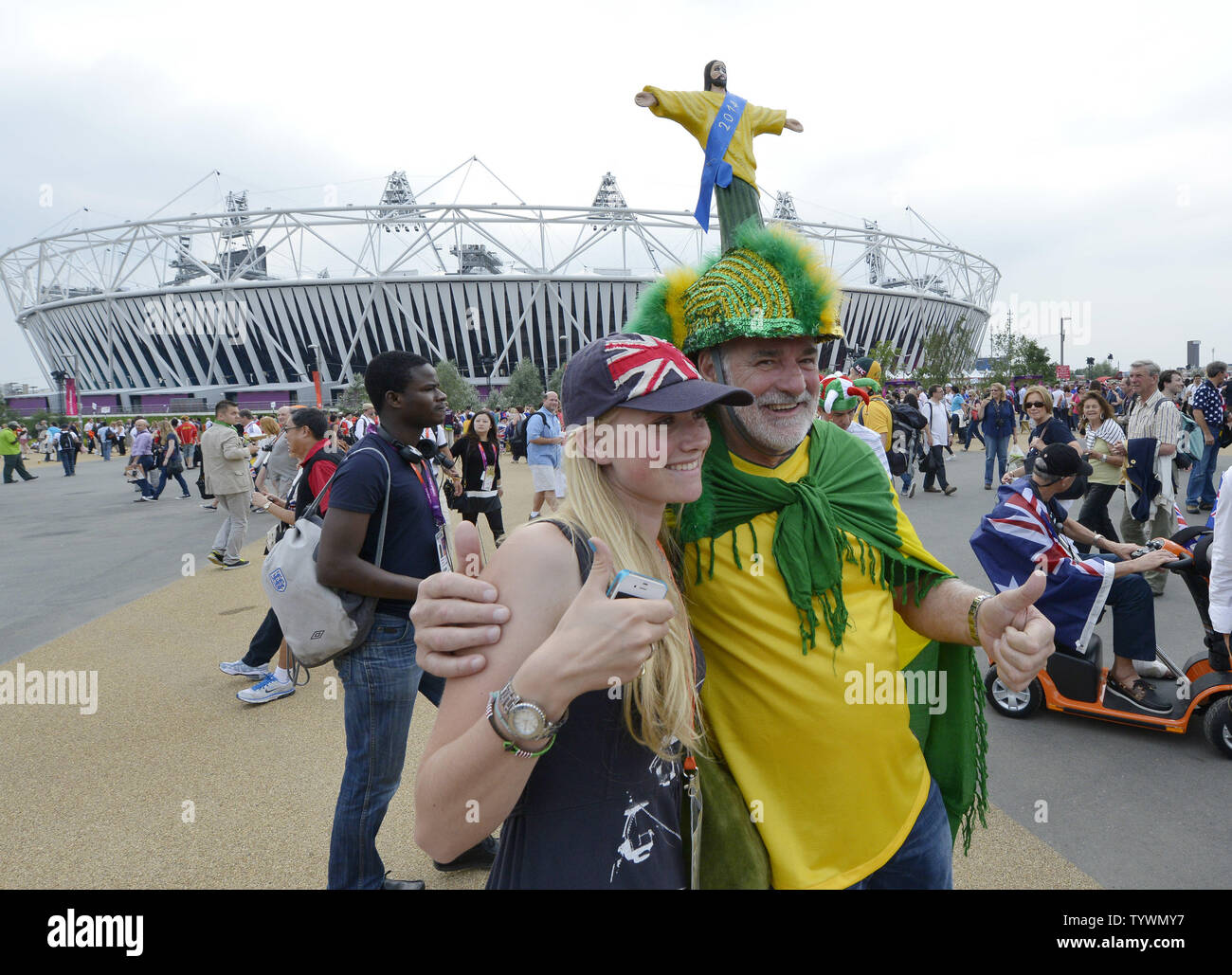 Olympic fans Nesta Wigan (L) and Amadeu Russi of Brazil pose for photos in front of the Olympic Stadium at the London 2012 Summer Olympics on July 27, 2012 in Stratford, London.   UPI/Brian Kersey Stock Photo