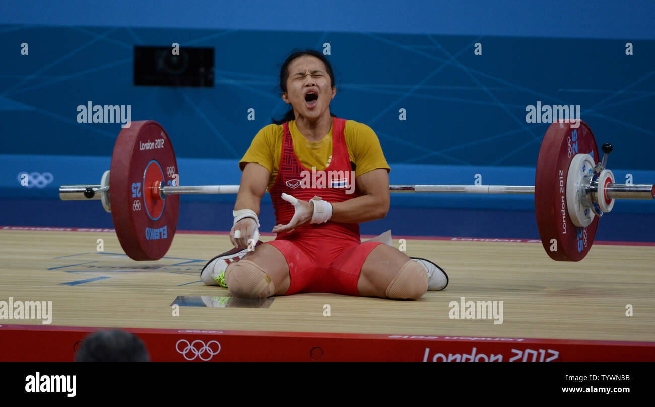 Panida Khamsrri of Thailand drops the weights with an injured elbow in