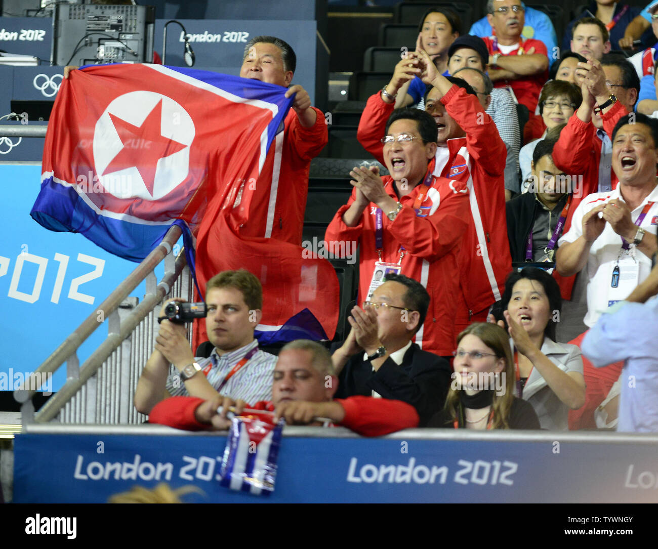 Members of the Peoples Republic of Korea (North Korea) team celebrate Kum Ae An's victory over Yanet Bermoy Acosta of Cuba in the Women's Judo 52kg Gold Medal match at the London 2012 Summer Olympic Games on July 29, 2012 in London. UPI/Ron Sachs Stock Photo