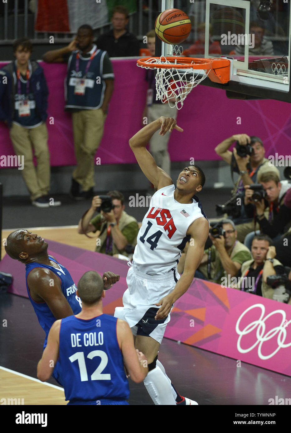 United States' Anthony Davis, who also plays for the NBA's New Orleans Hornets, goes for a rebound against France's Nando de Colo (12) and Ali Traore during the United States-France Men's Basketball Preliminary competition at the 2012 Summer Olympics, July 29, 2012, in London, England.              UPI/Mike Theiler Stock Photo