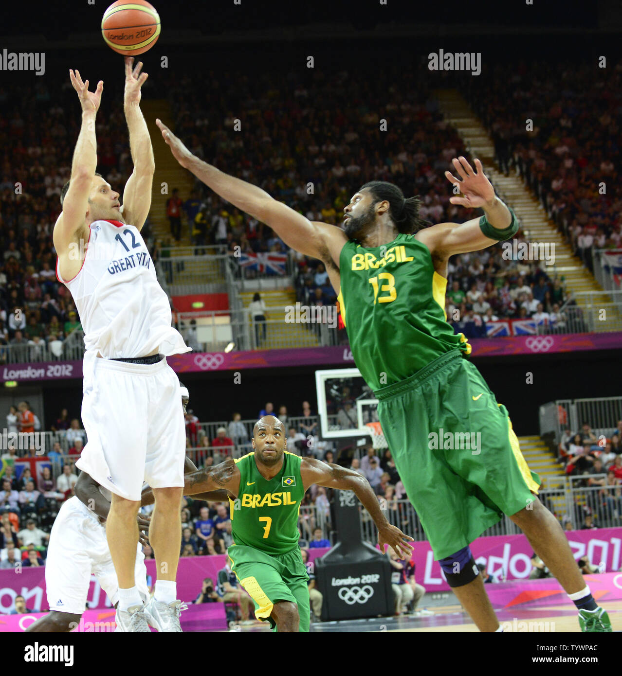 Guard Nate Reinking (12) of Great Britain shoots over center Nene Hilario (13) of Brazil in second half action in a preliminary round - group B basketball game at the London 2012 Summer Olympics on July 31, 2012 in London. Brazil won the game 67 - 62.  UPI/Ron Sachs Stock Photo