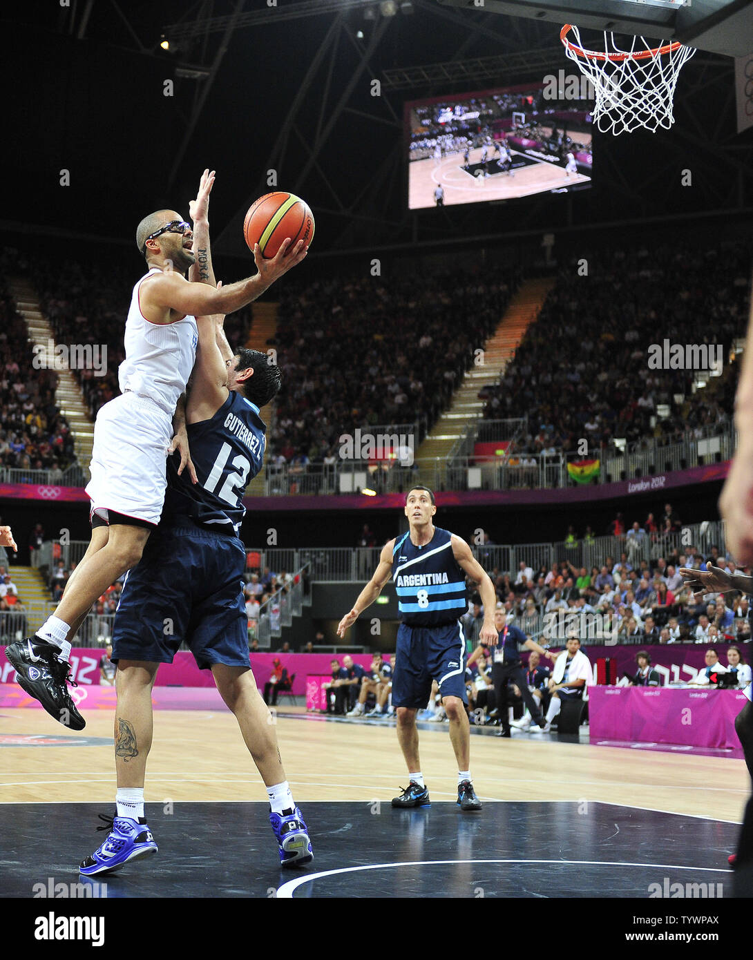 Tony Parker (9) of France drives to the basket over Leonardo Gutierrez (12) of Argentina in a preliminary round - group A basketball game at the London 2012 Summer Olympics on July 31, 2012 in London.  France won the game 71 - 64.  UPI/Ron Sachs Stock Photo